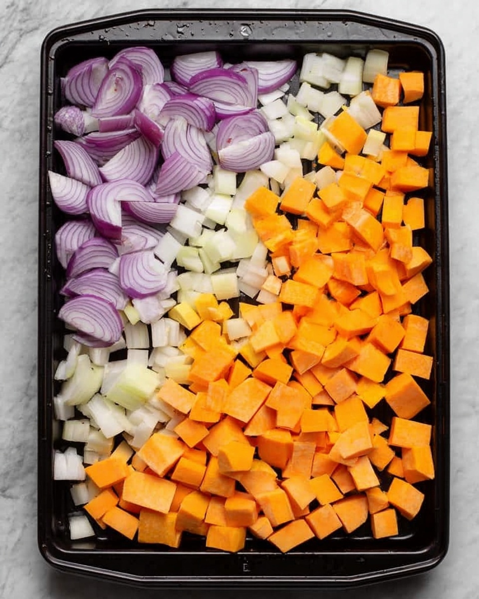 A black baking tray filled with four sections of chopped vegetables arranged side by side. On the left, there are thin slices of purple onion mixed with small pieces of white onion. Next to that, there are small cubes of white potato. To the right of the potatoes, there are slightly larger orange cubes of butternut squash. On the far right, the largest cubes are light orange sweet potato. The tray is placed on a white marbled surface. Photo taken with an iphone --ar 4:5 --v 7
