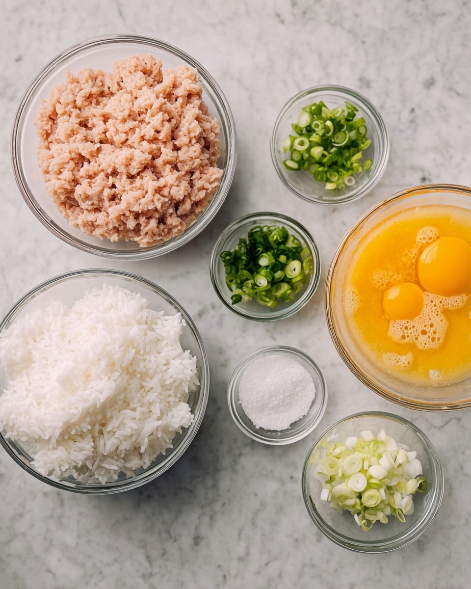 The image shows six clear glass bowls on a white marbled surface. The largest bowl at the bottom center holds plain white rice with a fluffy texture. To the left is a medium bowl filled with light pink ground meat, smooth and slightly wet. To the right of the rice is a medium bowl with beaten eggs, showing a bright yellow-orange color with some bubbles. Above the rice and eggs are three small bowls: one with finely chopped green onions, one with white and light green sliced scallions, and one with white salt. The arrangement is neat and the colors contrast well against the clear glass and white marbled background. Photo taken with an iphone --ar 4:5 --v 7