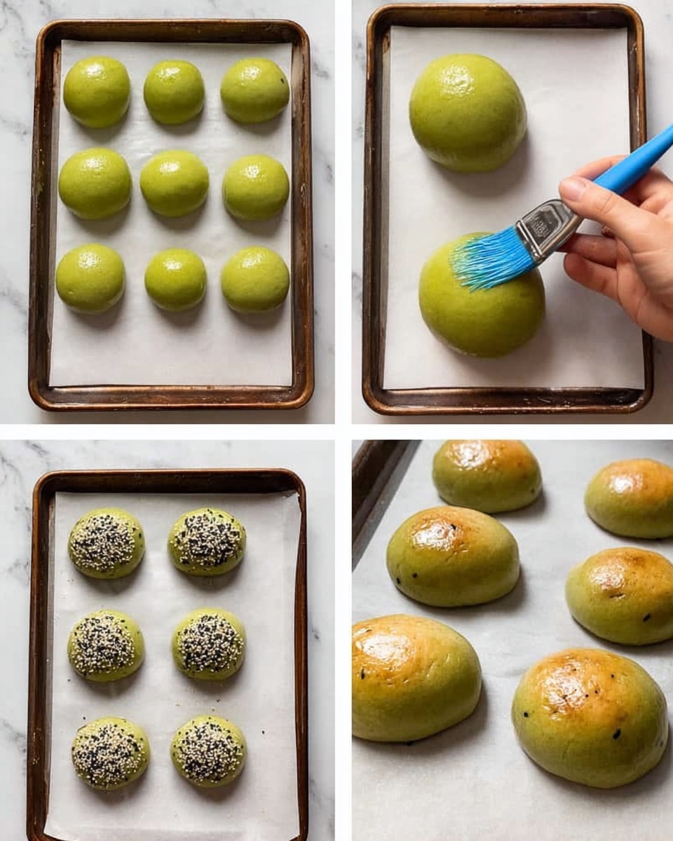 Spinach Burger Buns Recipe with Topping Recipe 5 The image shows two green sandwich buns with sesame seeds on top resting on brown parchment paper on a white marbled surface. One bun is whole, and the other is opened, showing its soft, green interior. At the top right, there is a white bowl filled with fresh green spinach leaves. To the top left, another white bowl holds more green buns with sesame seeds. A small white container of creamy beige sauce is placed near the buns. The scene is arranged neatly, with natural lighting highlighting the fresh and vibrant colors of the food. Photo taken with an iphone --ar 4:5 --v 7