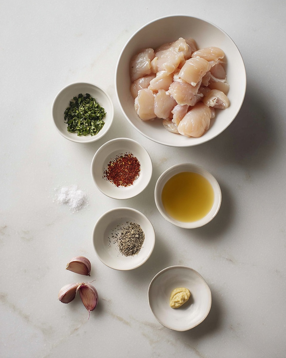 The image shows a white bowl at the top filled with small pieces of raw chicken, pale pink and slightly shiny. Below it are six small white bowls arranged in two vertical lines on a white marbled surface. The top left bowl holds finely chopped green herbs, while the top right bowl contains a golden yellow liquid. The middle left bowl has a mix of coarse black pepper, white salt, and green dried herbs. The middle right bowl is empty with a faint reddish tint inside. The bottom left bowl contains red spices, with two garlic cloves beside it on the surface. The bottom right bowl has a small dollop of pale yellow mustard or paste. The setup looks clean and minimal. Photo taken with an iphone --ar 4:5 --v 7