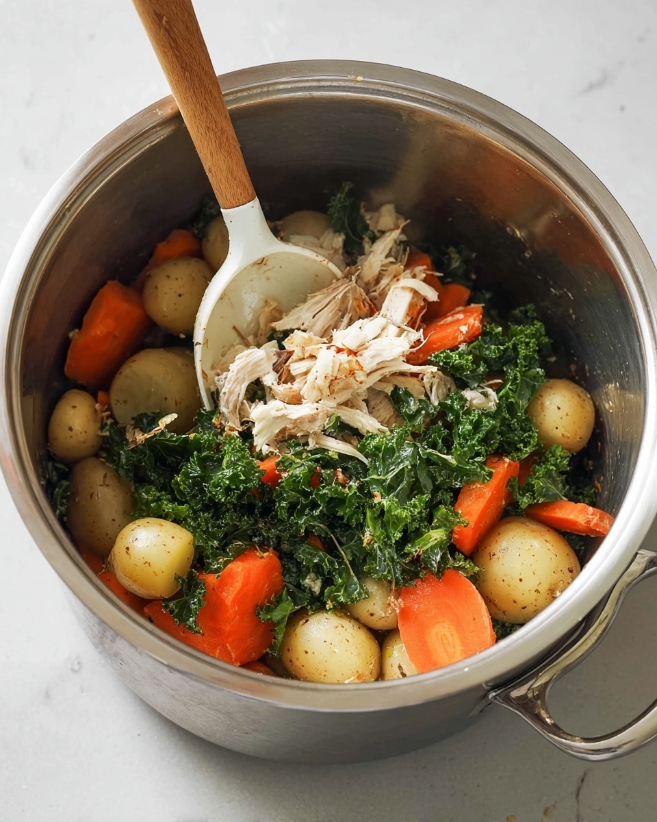 Inside a shiny silver pot on a white marbled surface, there is a mix of cooked ingredients. The bottom layer shows light brown small round potatoes, cut in halves, with an uneven texture. Scattered among them are bright orange thick carrot slices with smooth edges. Bright green, curly kale leaves with a slightly rough texture are mixed in the middle layer. On top and throughout are shredded pieces of pale white meat, resting lightly over the other layers. A white ladle with a smooth surface and a wooden handle is scooping some of the shredded meat and vegetables. The scene looks simple and warm, ready to serve photo taken with an iphone --ar 4:5 --v 7