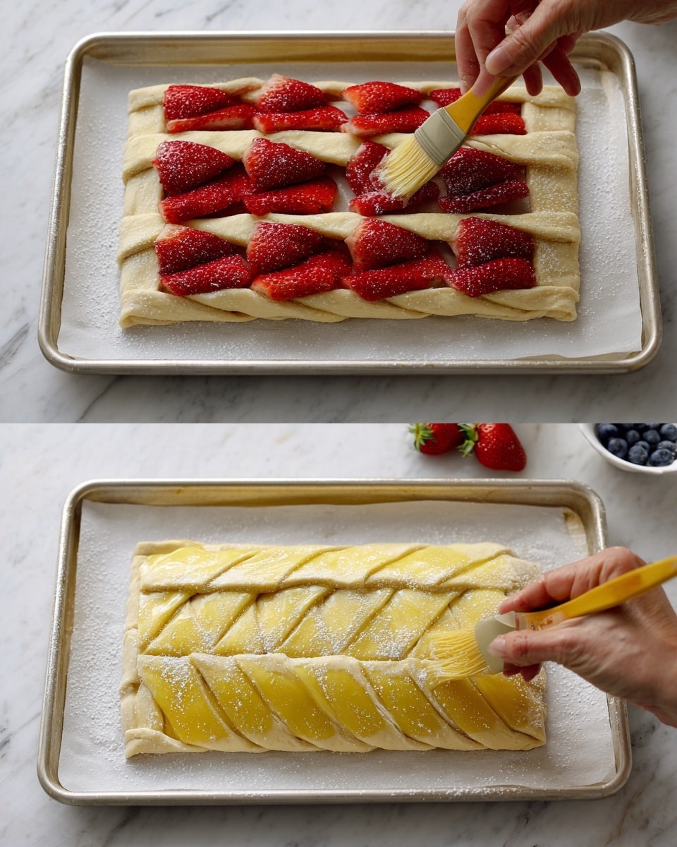 The dish shows a braided pastry with fresh strawberry filling. The first layer is a rectangular light-colored dough base with vertical strips cut on the sides. The second layer is fresh red strawberry halves placed neatly in the center of the dough base. The third layer shows strips of dough being braided over the strawberry layer, alternating from both sides to the center, creating a woven pattern. The final layer is a golden yellow brushed egg wash coating the braided dough with a sprinkle of sugar on top. The pastry is on a white baking tray lined with parchment paper, with a white marbled surface background, and a woman's hand is shown brushing the egg wash on the dough. Photo taken with an iphone --ar 4:5 --v 7