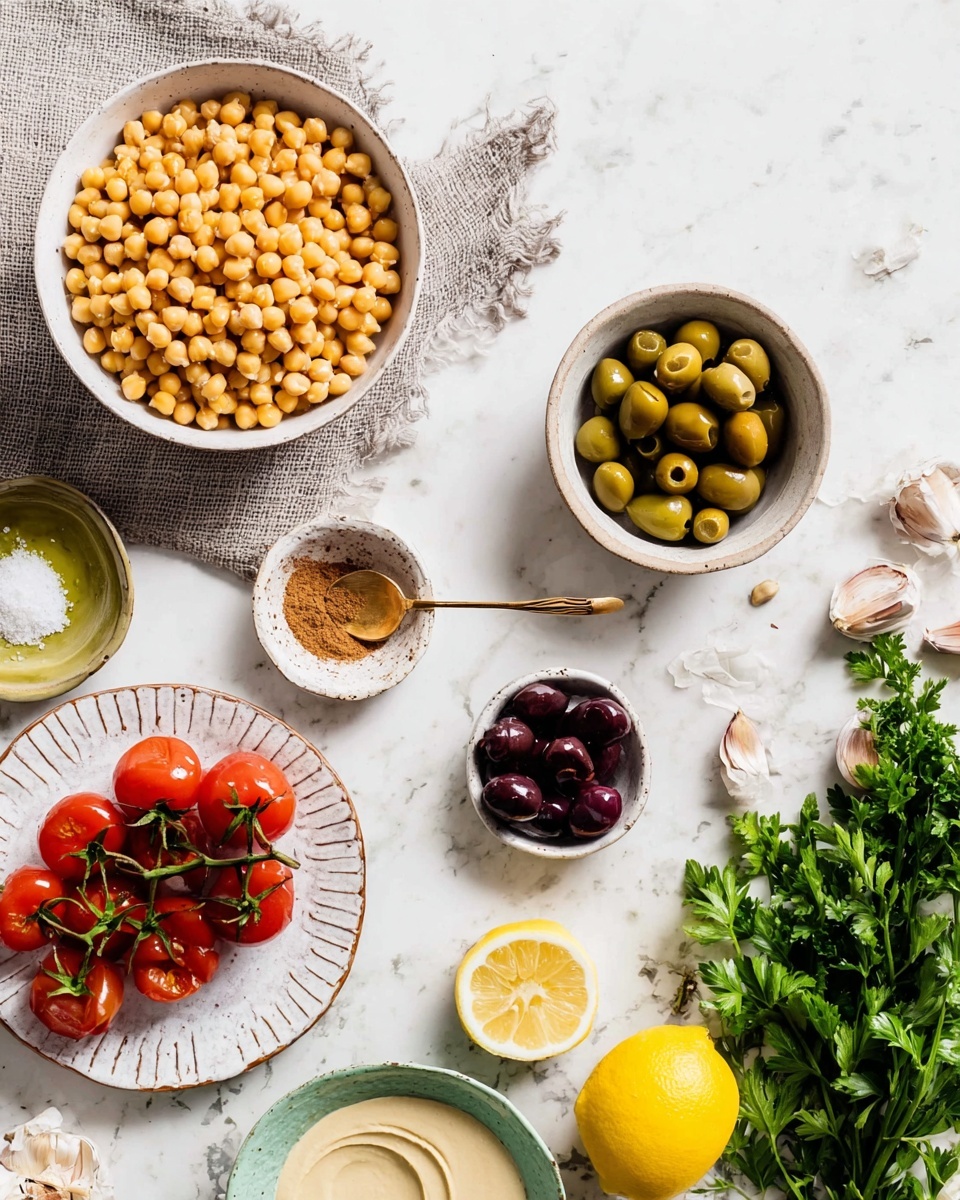 The image shows several small white bowls and plates placed on a white marbled surface. In the top left, a bowl filled with many yellow chickpeas rests partly on a gray cloth. Below it, a bowl holds green olives, while a nearby plate contains a cluster of bright red cherry tomatoes still on the vine. In the center sits a small bowl with a brown powdered spice and a tiny golden spoon resting on it, next to a small bowl of coarse salt with a tiny spoon. On the right side, a small white bowl holds dark purple olives, a pale green bowl of smooth beige tahini is nearby, and next to it is a bundle of fresh green parsley and halved yellow lemons. Garlic cloves are scattered near the parsley and lemons. The photo looks bright and clean. photo taken with an iphone --ar 4:5 --v 7