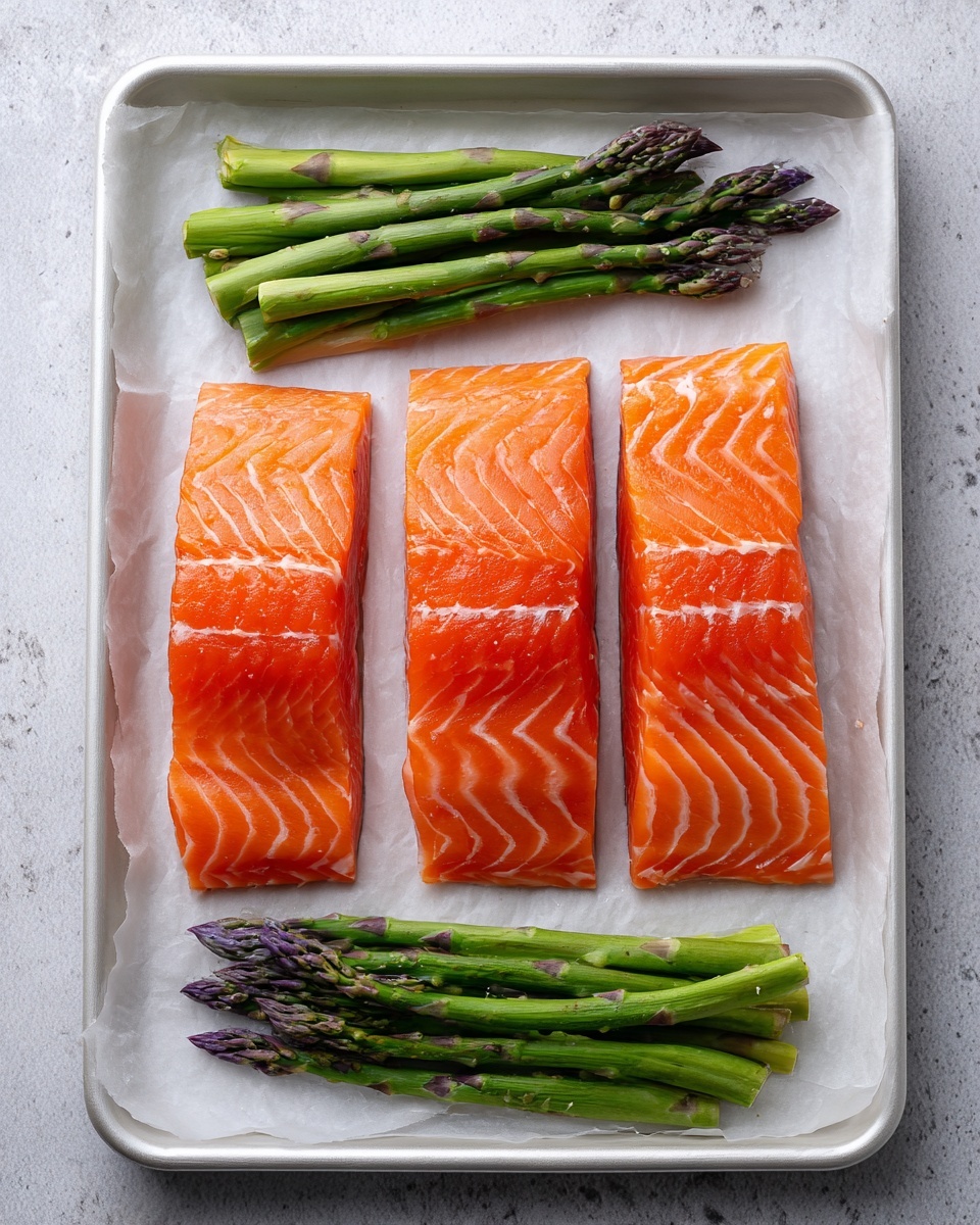 The image shows a baking tray with three long, pinkish-orange cooked salmon fillets placed in the center, each topped with a layer of melted light yellow cheese and sprinkled with chopped green herbs, giving a fresh look. On both sides of the salmon, there are bunches of bright green asparagus with some melted cheese on top, slightly browned at the tips. The tray is lined with white parchment paper, and the whole scene is set on a white marbled surface with some scattered green herbs around for decoration. Photo taken with an iphone --ar 4:5 --v 7