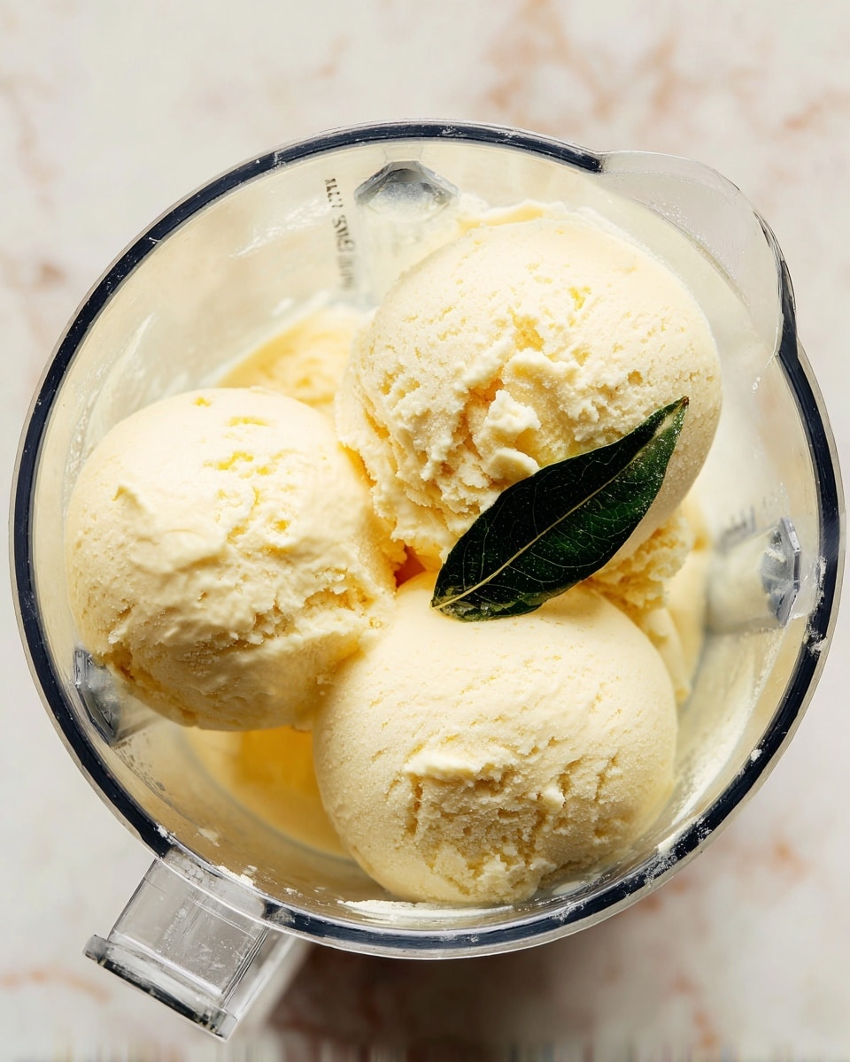 A clear glass is filled with a bright green drink that has a light frothy top layer. On the top, there is a thick swirl of white whipped cream covering the whole surface, decorated with small round green and white sprinkles scattered across it. A bright red cherry with a stem sits in the center of the whipped cream swirl. Two green straws with white polka dots are placed sticking out from the right side of the whipped cream. The glass is placed on a white marbled textured surface, with some blurred green shapes in the background. Photo taken with an iphone --ar 4:5 --v 7