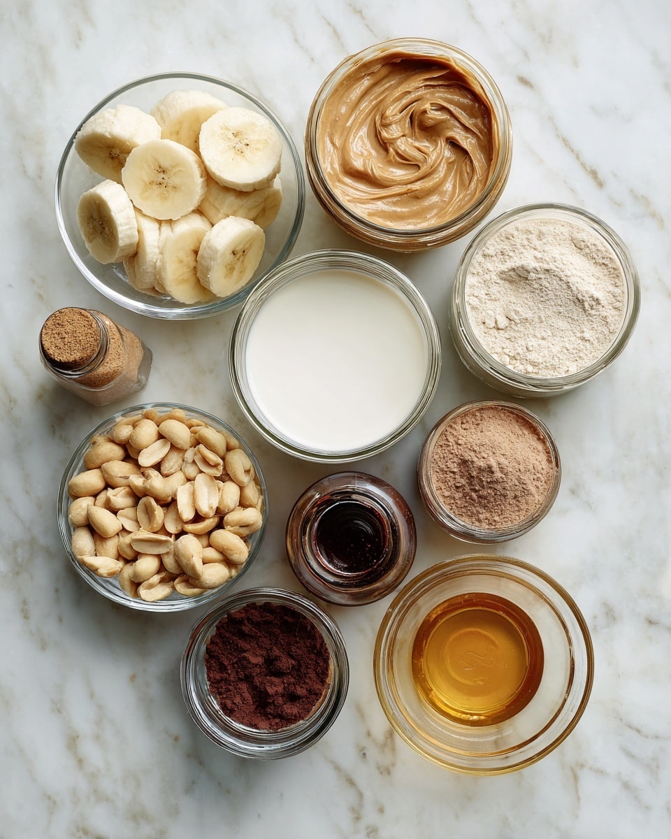 The image shows a white marbled surface with several small clear bowls and jars arranged neatly. Starting from the top left, there is a clear bowl filled with round banana slices, some looking slightly frozen. Next to it is an open jar of smooth light brown peanut butter with a swirled texture on top. Below the bananas is a jar of white milk and to the right of it, a jar filled with light brown powder, likely flour. Next to the peanut butter on the right is a small dark brown bottle, and below that a jar containing dark reddish-brown powder, likely cocoa. Below the milk is a small clear bowl with dark brown liquid, and next to it, a jar filled with chopped peanuts showing different shades of beige and tan. Finally, on the far right, there is a small clear bowl filled with golden honey. photo taken with an iphone --ar 4:5 --v 7