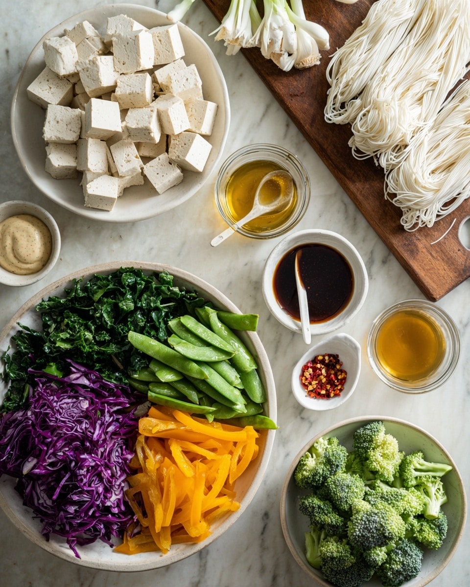 The image shows a top view of fresh ingredients arranged on a white marbled surface. On the left, a white bowl filled with layers of colorful vegetables: dark green leafy greens at the bottom, bright orange sliced peppers on the right, light green snap peas in the middle, and vibrant purple cabbage on the left. Above this bowl is a white plate holding evenly cubed beige tofu pieces. Nearby, two white garlic cloves lie between a bunch of long green onions and a pile of thin white noodles resting on a wooden board to the right. Two small white bowls hold golden liquid and dark brown sauce, respectively, while a glass bowl near the bottom holds a creamy light brown sauce with a white spoon inside. A small white spoon above has red chili flakes scattered on the surface. Below the colorful vegetable bowl, a white bowl with green broccoli florets completes the image. The photo taken with an iphone --ar 4:5 --v 7