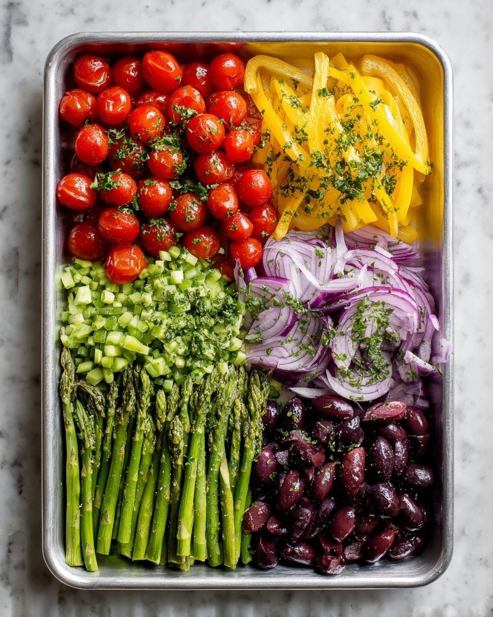 A white plate sits on a gray striped cloth on a white marbled surface, holding a dish with a thick white fish fillet as the main top layer. The fish is lightly seasoned with black specks and garnished with a small wedge of lemon, a few green asparagus tips, and slices of purple onion. Below the fish is a colorful mix of vegetables including yellow and green carrot-like strips, green asparagus, whole small red cherry tomatoes, and purple onion slices scattered around. A silver fork rests on the plate near the fish. In the blurred background, there is a silver baking tray with more vegetables and a wooden board with small bowls containing seasonings photo taken with an iphone --ar 4:5 --v 7