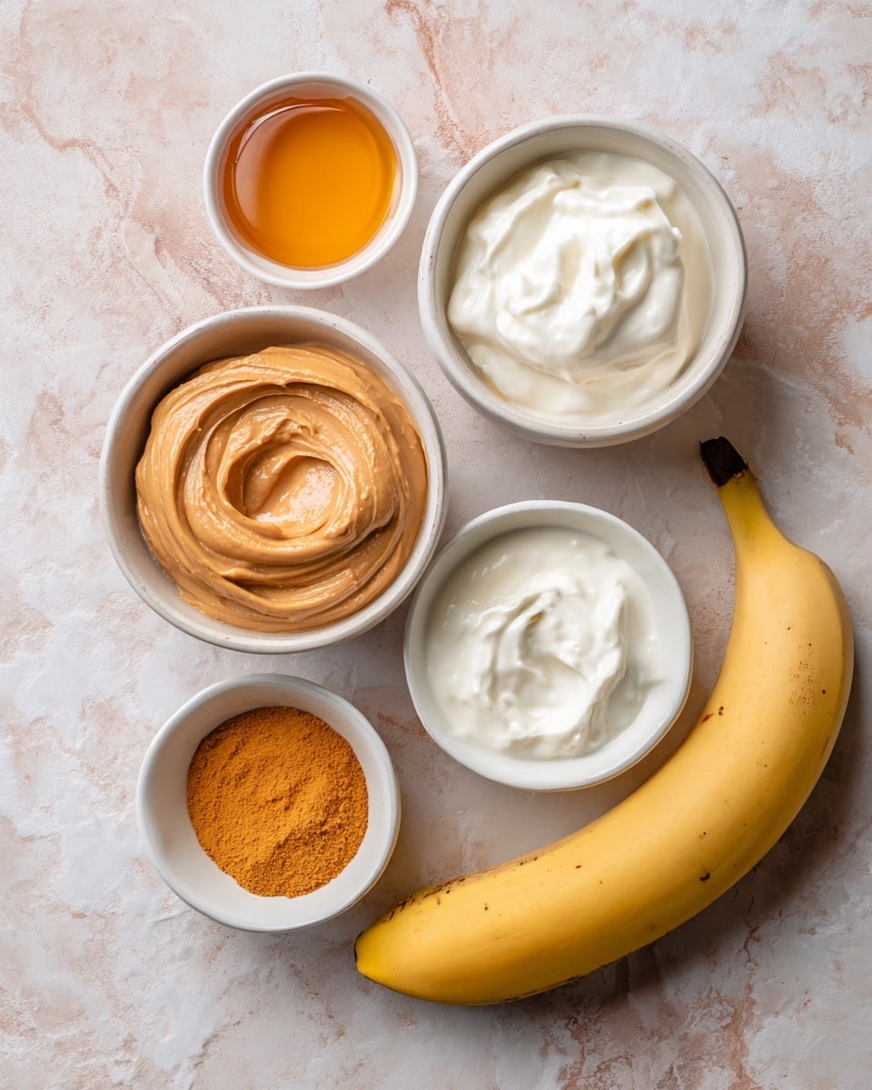 The image shows five items on a soft textured cloth with a white marbled texture underneath: a whole yellow banana on the right side, a small white bowl filled with smooth light brown peanut butter in the center, a slightly larger white bowl with thick white yogurt at the top right, a small white bowl with orange powder at the bottom left, and a small white bowl with thick golden honey at the top left. All bowls have smooth, clean surfaces and the banana is ripe with a few small brown spots. The colors are warm and natural, arranged neatly in a flat lay style. photo taken with an iphone --ar 4:5 --v 7