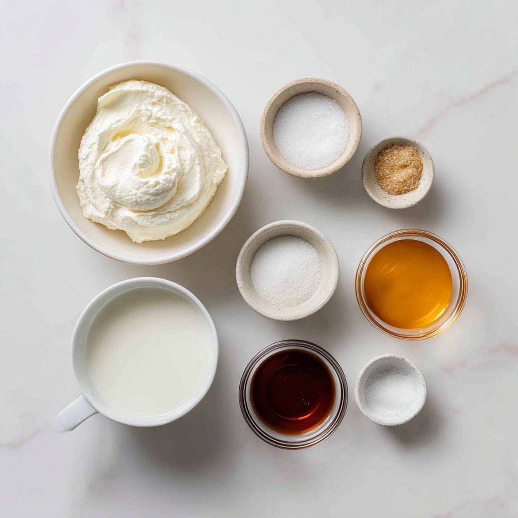 A top view of a metal bowl filled with a smooth, creamy, off-white mixture with a small dollop in the center, sitting on a white marbled surface. Beside the bowl on the right is a metal whisk attachment placed flat on the surface. The creamy mixture looks thick and well-blended, with a few small bubbles on the surface, showing a soft texture. photo taken with an iphone --ar 4:5 --v 7