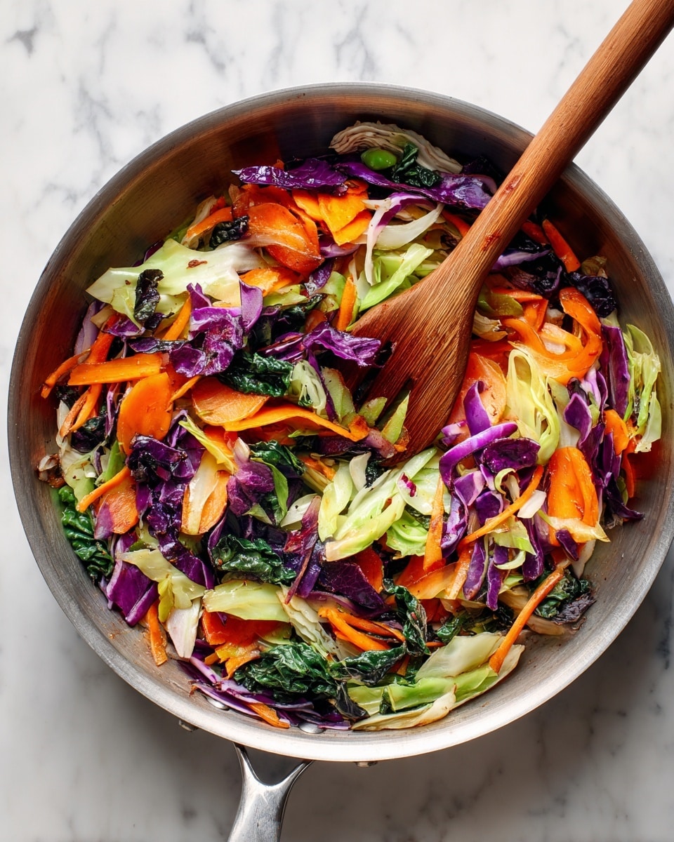 A white plate with blue patterns holds a pile of yellow cooked noodles mixed with light golden cooked chicken pieces, dark green leafy vegetables, thin slices of bright orange carrot, purple cabbage strips, and light green chopped scallions scattered on top, all sprinkled with white sesame seeds. A woman's hand with bright orange nail polish is holding light wooden chopsticks on the right side of the plate. In the top right corner, there is a glass with a yellow drink and a decorative chain. The setting is on a white marbled textured surface. photo taken with an iphone --ar 4:5 --v 7