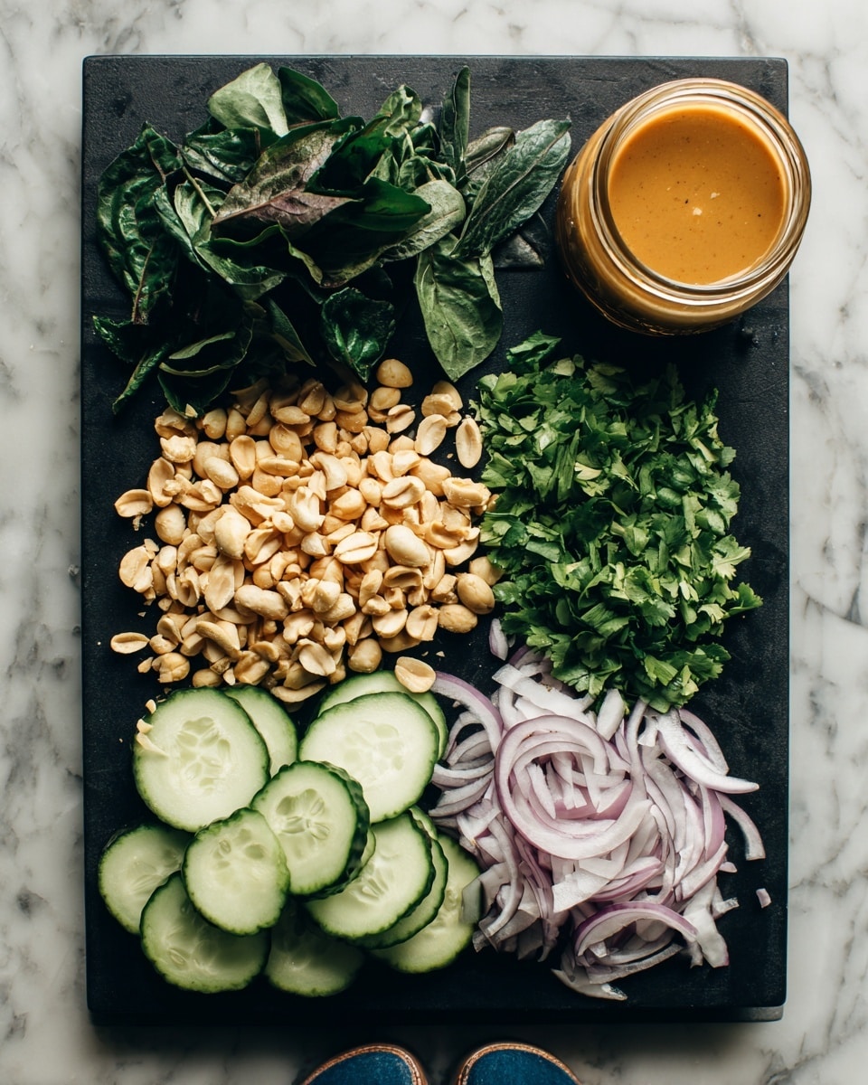 The image shows a black cutting board on a white marbled surface, featuring five sections of ingredients. From left to right, there is a pile of fresh dark green leaves, followed by a heap of roughly chopped light brown peanuts, then a bunch of chopped vibrant green herbs, next a neat stack of thinly sliced light green cucumber rounds showing seeds, and finally thinly sliced pale purple onion rounds arranged beside a glass jar filled with a smooth orange-brown sauce. Two legs wearing dark blue pants are visible below the table. Photo taken with an iphone --ar 4:5 --v 7