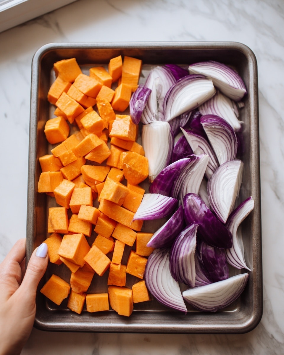 A metal tray holds two types of chopped vegetables evenly spread in separate sections; on the left, bright orange cubes with some skin showing, giving off a rough texture, and on the right, thick slices of purple and white onion layers, each piece curved and glossy with a smooth surface. A woman's hand is gently holding the bottom edge of the tray, visible from the left corner, with neatly manicured nails. The tray rests near a window, casting clear shadows over a white marbled surface beneath. photo taken with an iphone --ar 4:5 --v 7