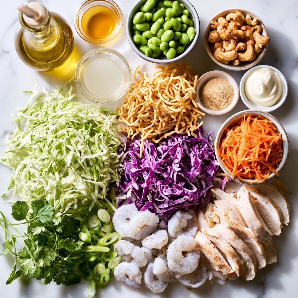 A clear glass bowl holds a colorful salad with six distinct layers arranged side by side: purple shredded cabbage on the left edge, thinly shredded white cabbage next to it, bright green chopped herbs in the middle left, chopped roasted peanuts covered in a light dressing in the center, green edamame beans to the middle right, and long sticks of bright orange carrots on the right edge. A woman's hand pours a light yellow dressing from a small glass jar above, partially blurred in the foreground. The bowl sits on a white marbled surface with soft natural light. photo taken with an iphone --ar 4:5 --v 7