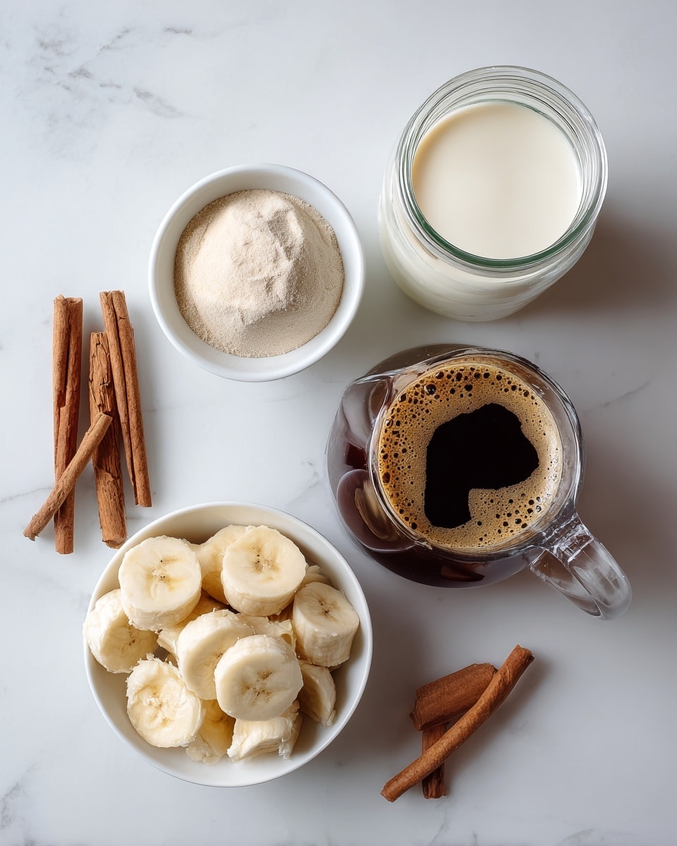 The image shows four items arranged on a white marbled surface: at the top right, a clear glass jar filled with creamy white milk; below it, a clear glass pitcher filled with dark brown coffee topped with a light brown foam ring; at the bottom left, a white bowl filled with sliced frozen bananas and some small frozen chunks; and to the left of the milk jar, a white bowl holding a round scoop of pale beige powder, with two brown cinnamon sticks placed beside this bowl. Photo taken with an iphone --ar 4:5 --v 7