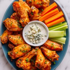 Baked Buffalo Wings with Hot Sauce, Blue Cheese Dressing, and Celery Recipe