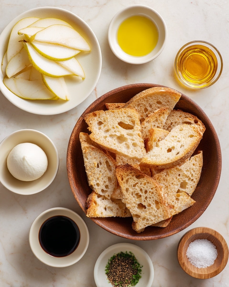 The image shows a wooden bowl in the center filled with many pieces of toasted bread slices that have a light golden brown crust and airy texture with holes. To the left of the bowl is a white plate with thin slices of light yellow pear with brown edges arranged in layers. Surrounding the bowl and plate are small white bowls with different items: golden honey, dark brown soy sauce in a glass container, bright yellow olive oil, and chopped green herbs. To the right of the bowl are three small round bowls: a white bowl with a smooth round ball of white cheese, a black bowl with coarse salt, and a small wooden bowl with ground black pepper. Everything is on a white marbled surface. Photo taken with an iphone --ar 4:5 --v 7