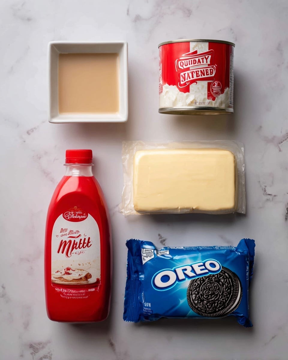The image shows six ingredients arranged on a white marbled surface in two rows. The top row has four items: a small white square dish with a light brown liquid on the left, next to a red and white can of sweetened condensed milk, followed by a red and white carton of heavy whipping cream, and a pale yellow wrapped block of salted Irish butter on the right. The bottom row has two items: a red and white bottle of malted milk on the left and a large blue package of Oreo cookies on the right. All items are neatly placed with bright, clear packaging colors. Photo taken with an iphone --ar 4:5 --v 7