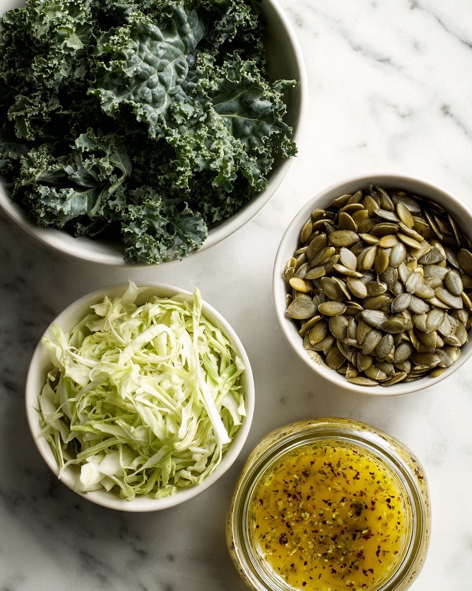 A white plate with a blue scalloped edge holds two layers of greens: on the left side, light green shredded cabbage with thin, pale strips, and covering the rest of the plate, dark green curly kale leaves with a rough texture. To the top right of the plate on a white marbled surface, there is a small white bowl filled with green and brown pumpkin seeds and next to it a glass jar of yellowish-brown dressing with specks. photo taken with an iphone --ar 4:5 --v 7