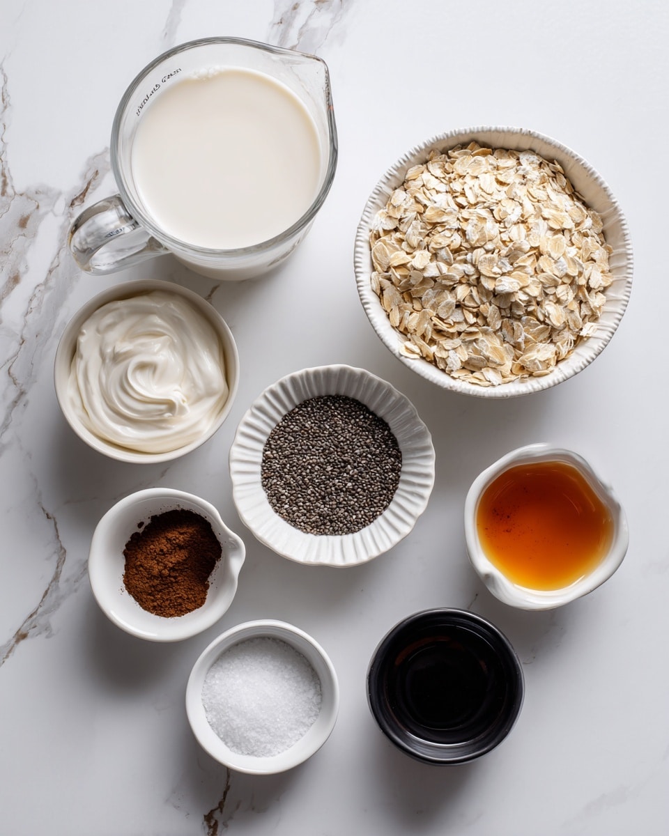 The image shows a top view of eight small containers arranged on a white marbled surface. There is a large clear glass measuring cup filled with milk on the left side. Next to it are two small white bowls, one with a light cream swirl of yogurt and the other with black chia seeds. Above the yogurt is a ridged white bowl filled with light brown rolled oats. Near the top right corner is another ridged bowl with dark brown cocoa powder. Beside it, a small white bowl contains a dark amber liquid, likely vanilla or syrup. There is a small white bowl with dark vanilla extract next to a smaller black bowl filled with coarse salt. The bowls vary slightly in shape but keep a simple, clean look. The photo taken with an iphone --ar 4:5 --v 7
