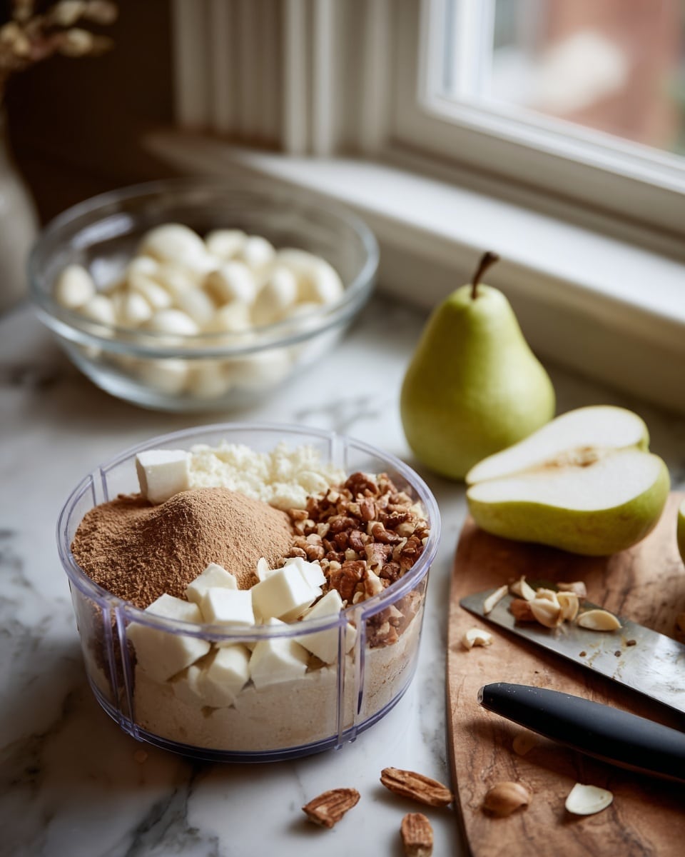 The image on the left shows a clear plastic food processor bowl filled with several layers of ingredients: a light beige powdery layer on the bottom, topped with a darker brown spice powder, some creamy white chunks on one side, and crushed nuts scattered in a semicircle around the edge. The image on the right shows a wooden cutting board on a white marbled surface with two halves of a peeled pale green pear placed near the center, a green pear standing upright close to the window in the background, a glass bowl filled with white peeled garlic cloves, a black knife and a black peeler lying flat on the board. The background features a softly lit window. Photo taken with an iphone --ar 4:5 --v 7