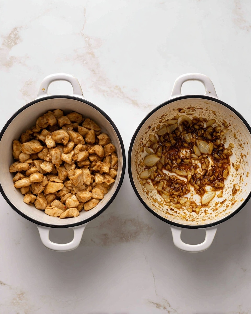 The image shows two white pots with black rims on a white marbled surface, each filled with different contents. The pot on the left is filled with many small, light brown cooked chicken pieces with a soft texture, showing some caramelized oil around them causing a slight shine. The pot on the right contains a thin layer of browned onions and garlic residue spread unevenly on the bottom, with some bits sticking to the sides and slightly darker areas near the edges. Both pots have a slightly worn look inside from cooking. photo taken with an iphone --ar 4:5 --v 7