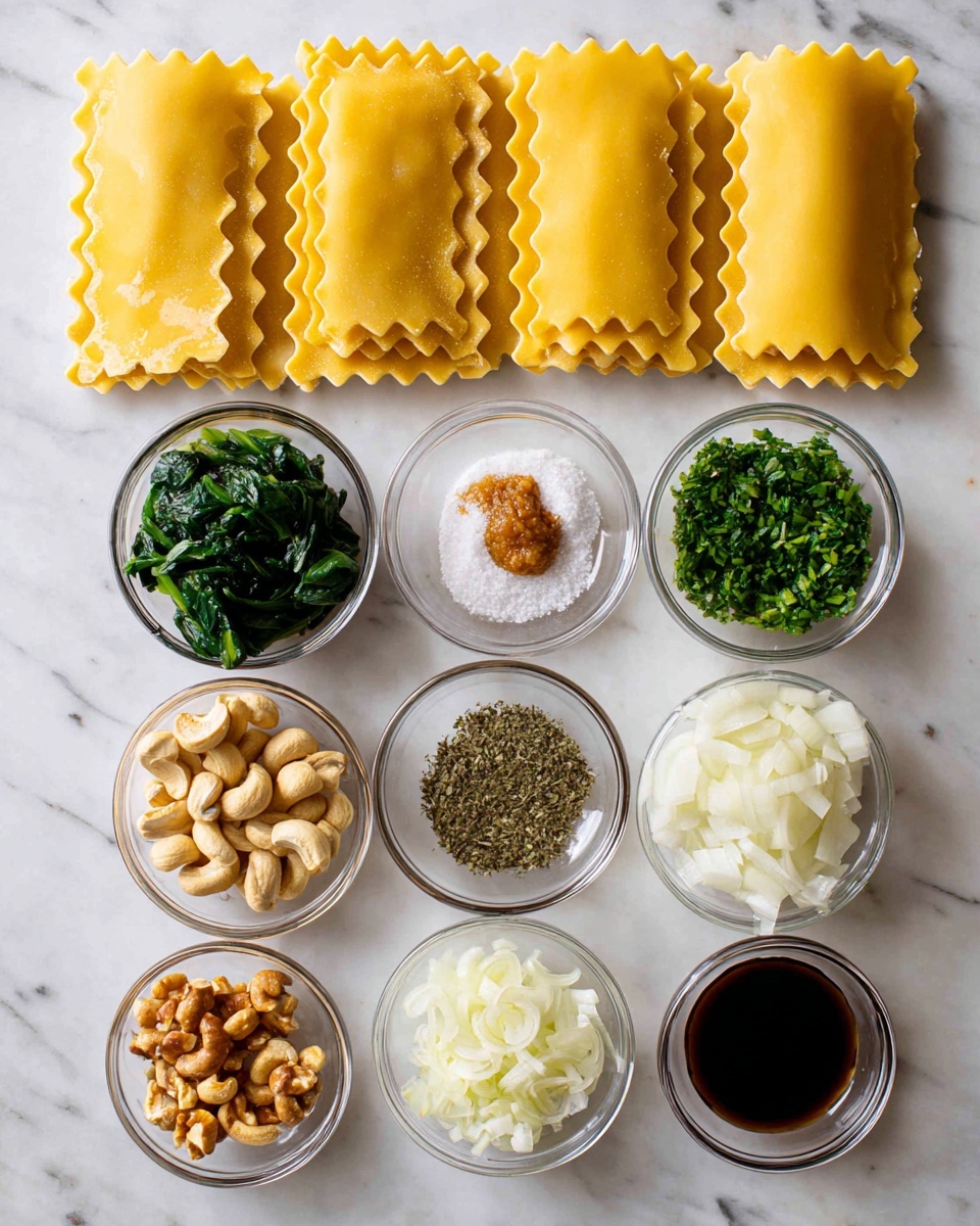The image shows a white marbled surface with ingredients neatly arranged for cooking. At the top, five uncooked yellow lasagna sheets are laid out flat with a wavy edge. Below the lasagna, there are eight small clear glass bowls containing different ingredients: chopped green spinach, white salt with black pepper, light brown cashew nuts, mixed dried herbs with a small dollop of a brown paste, chopped white mushrooms, finely chopped pale yellow garlic, dark brown soy sauce, more salt with pepper, and thinly sliced white onions. Each ingredient is clearly visible and well separated from the others. Photo taken with an iphone --ar 4:5 --v 7