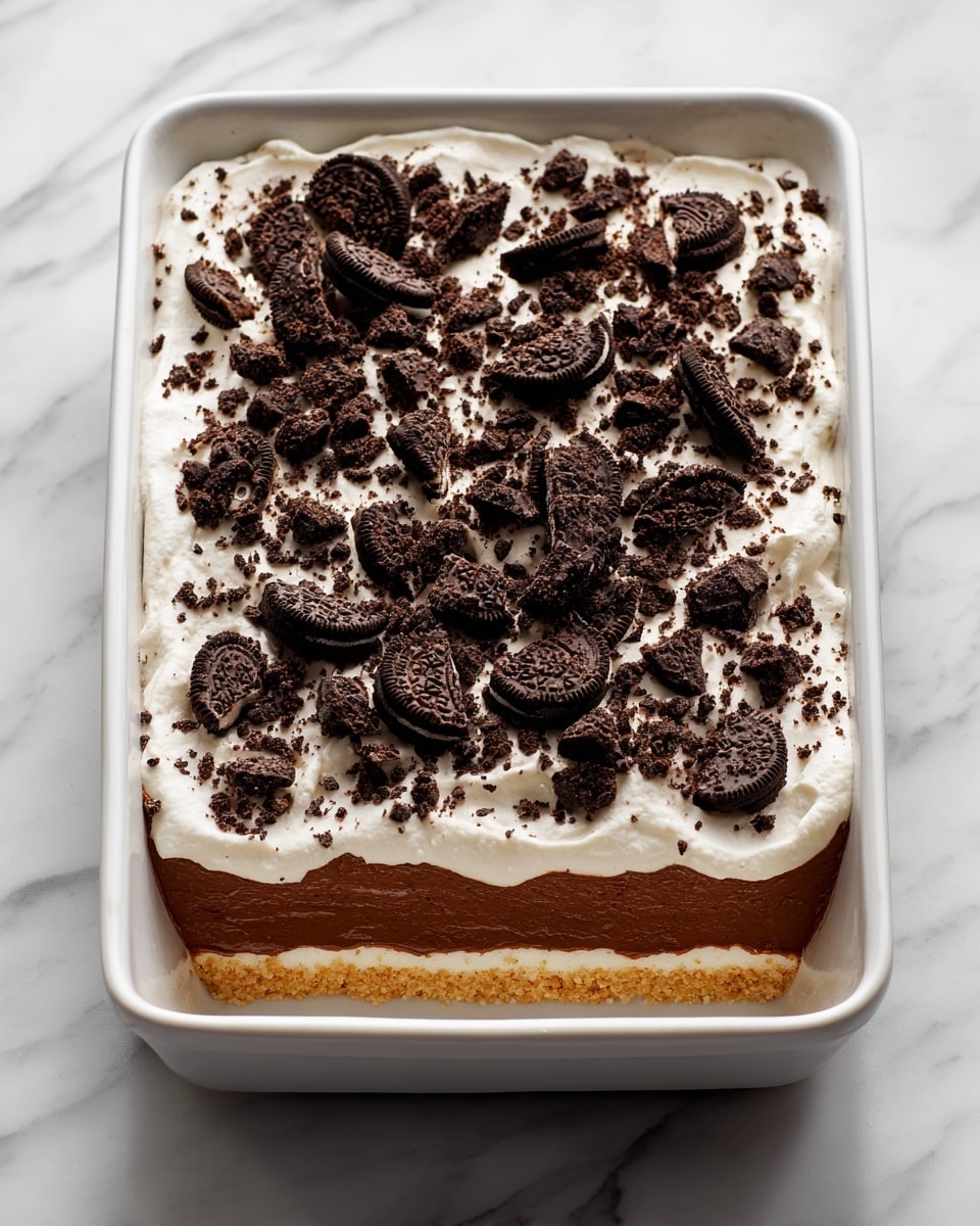 A three-layer dessert sits on a white plate with a white marbled background. The bottom layer is a dark brown, moist cake. On top of it is a thick, creamy beige filling with a smooth texture. Above this filling is another dark brown cake layer, then another thick creamy beige filling. The top layer is white whipped cream sprinkled with crumbled dark chocolate pieces and colorful candy-coated chocolate pieces. A woman's hand holds a spoon scooping out some dessert from the side. Photo taken with an iphone --ar 4:5 --v 7