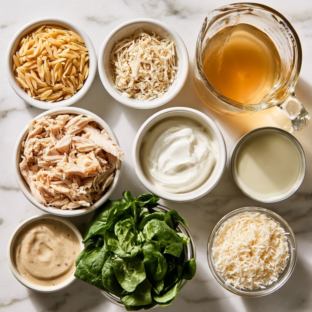 A white rectangular baking dish is placed on a white marbled surface, containing two distinct layers. The bottom layer is made of small, light brown orzo pasta filling the base evenly. On top of this is a thicker layer of shredded pale beige cooked chicken spread to cover the orzo completely. The dish is viewed from above, showing texture contrasts between the smooth orzo and the fibrous chicken. Photo taken with an iphone --ar 4:5 --v 7