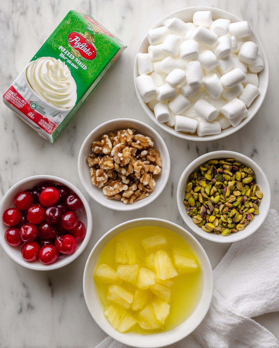 The image shows six white bowls arranged on a white marbled surface. The largest bowl at the bottom center contains bright yellow pineapple chunks in juice. Above it to the right is a bowl filled with smooth, fluffy white whipped cream. Above that is a bowl full of small white marshmallows with a soft, rounded texture. To the top right is a small bowl with green and brown chopped pistachios. To the left of the pistachios is a box of pistachio Jello instant pudding mix with green packaging and red and white text. Below the box, on the left, is another bowl filled with crushed light brown walnuts. Above the walnuts at the top left is a bowl of shiny red maraschino cherries. A white cloth is partially visible at the bottom right corner. photo taken with an iphone --ar 4:5 --v 7