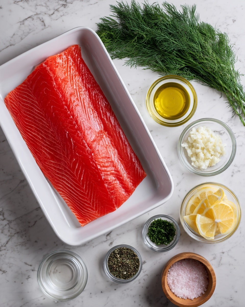 A large, bright red salmon fillet lays flat in a white rectangular dish, showing detailed texture and natural lines. To the right of the dish on a white marbled surface are six small bowls and items arranged vertically: a bunch of fresh green dill at the top, followed by a glass bowl of light golden olive oil, a glass bowl of finely chopped white garlic, a glass bowl of dark green dried herbs, three slices of pale yellow lemon, a small glass bowl of clear liquid, and a round wooden bowl filled half with coarse white salt and half with black pepper. The composition is clean and organized, with colors contrasting against the white marbled background. photo taken with an iphone --ar 4:5 --v 7